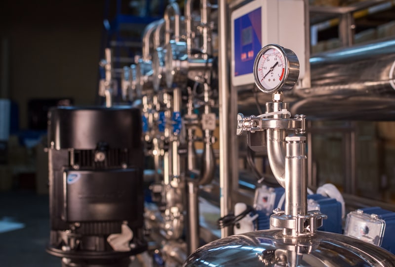Valves, pressure gauges and stainless piping in an industrial setting