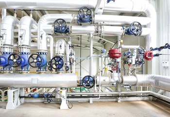 Valves in a mechanical room setting controlling steam pressure throughout the building