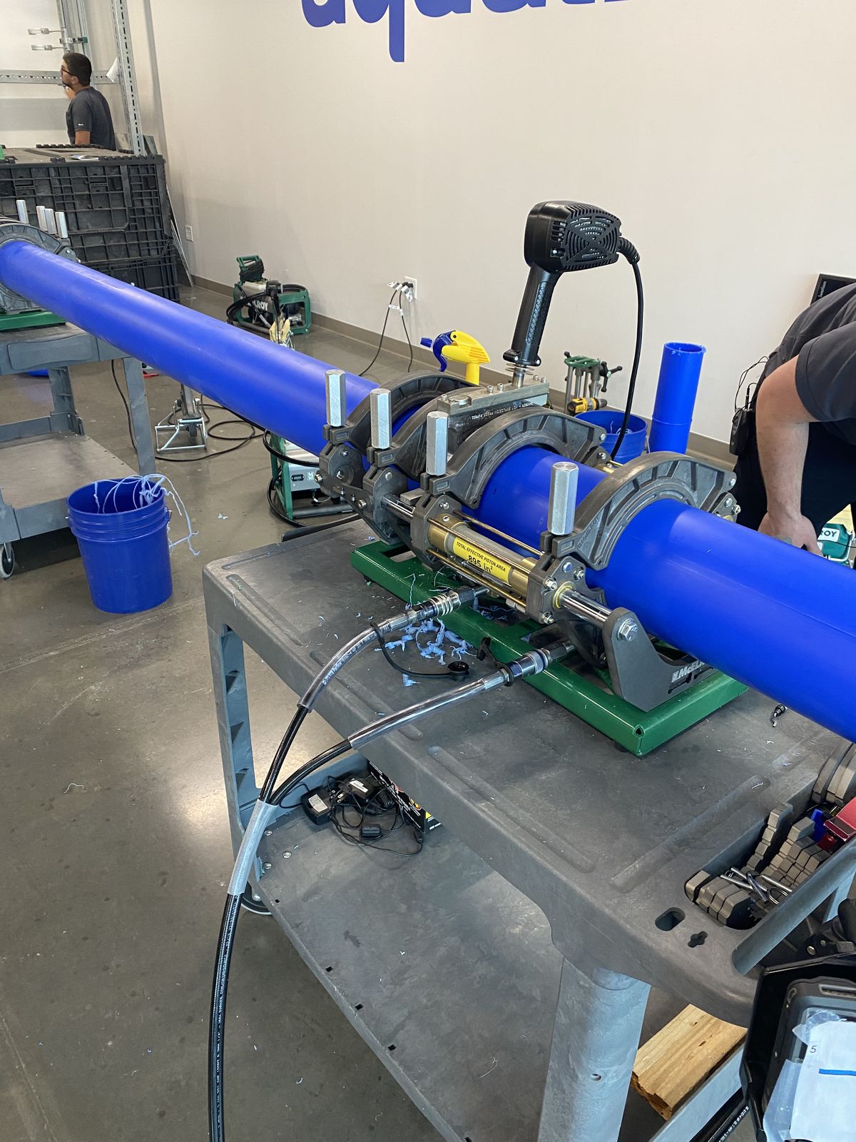 Butt-fusion machine clamped on blue PP-R pipe on a workstand