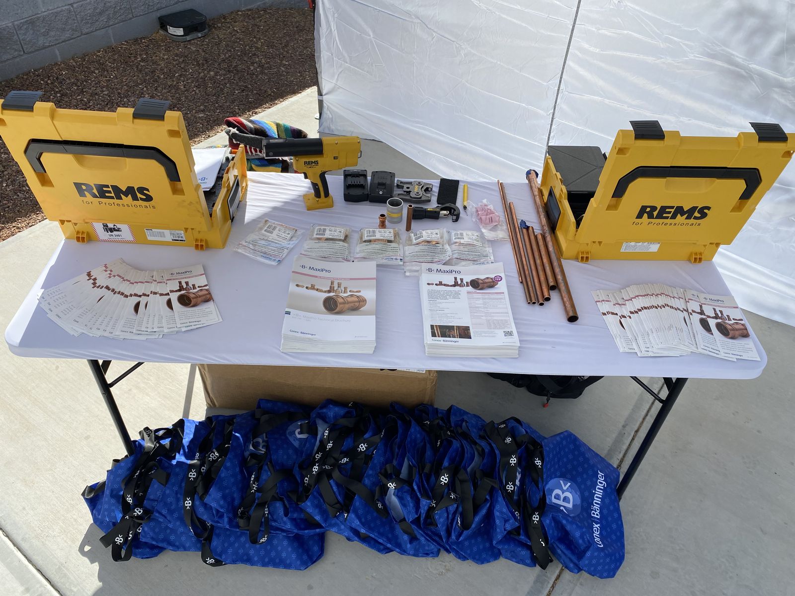 REMS tool cases with copper and press fittings on a display table
