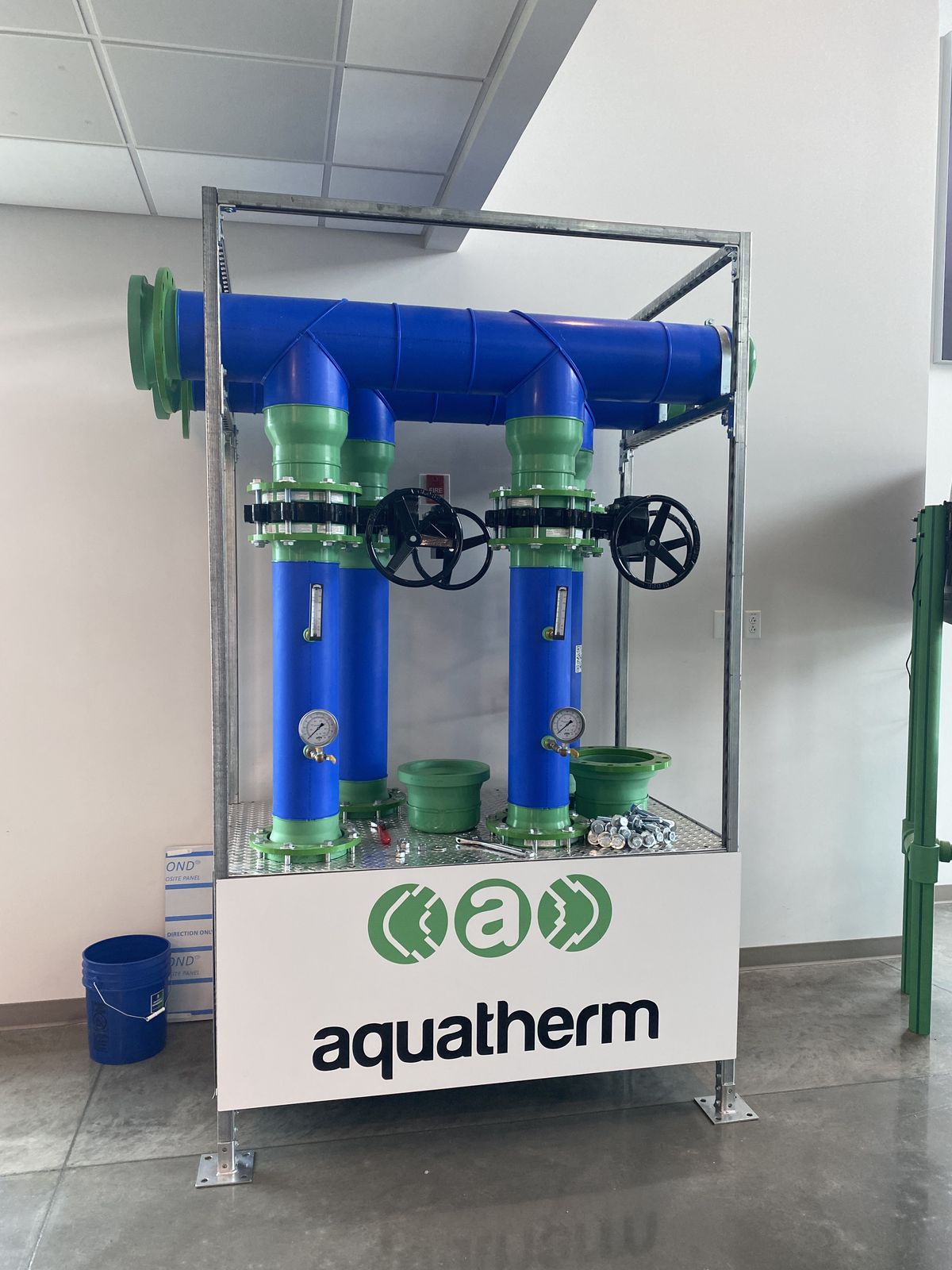 Aquatherm demonstration tower with green and blue PP-R piping and valves
