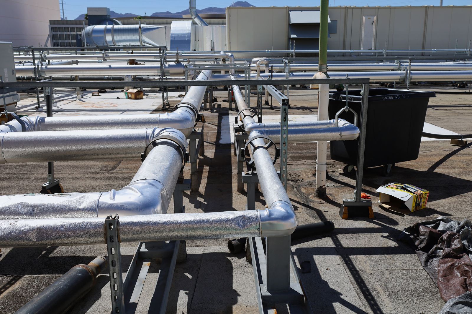 Rooftop run of aluminum-jacketed insulated piping on supports